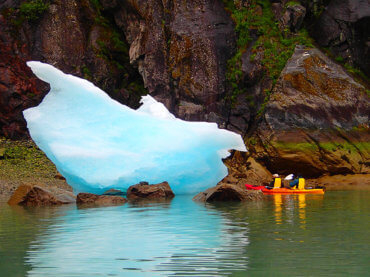 Kayakers Near Shore with Iceberg