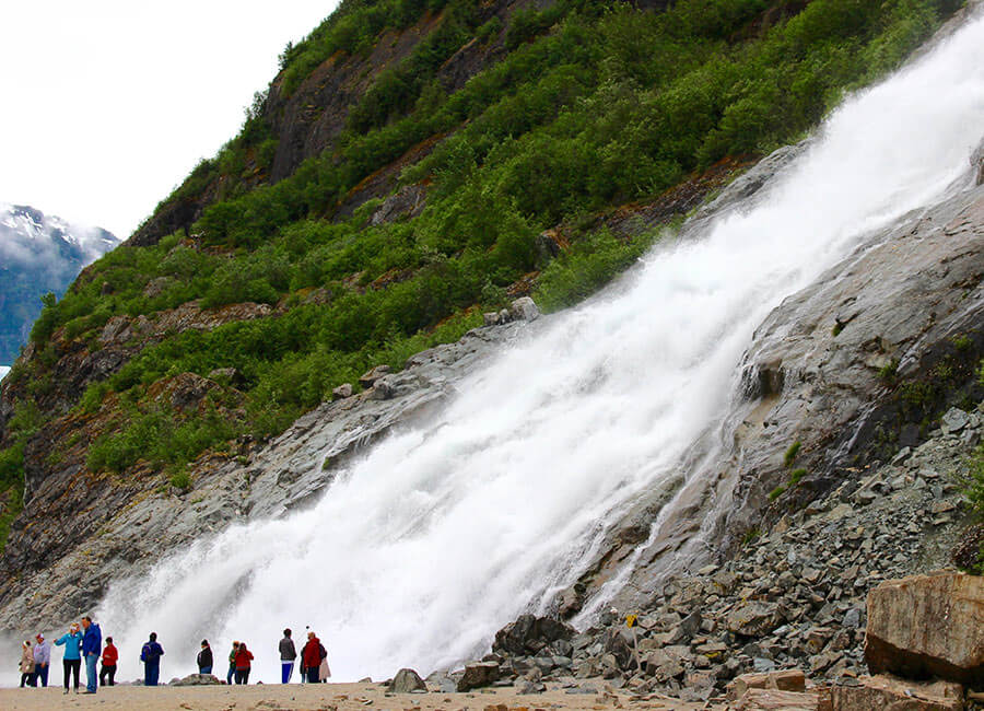 Group of Hikers and Waterfall