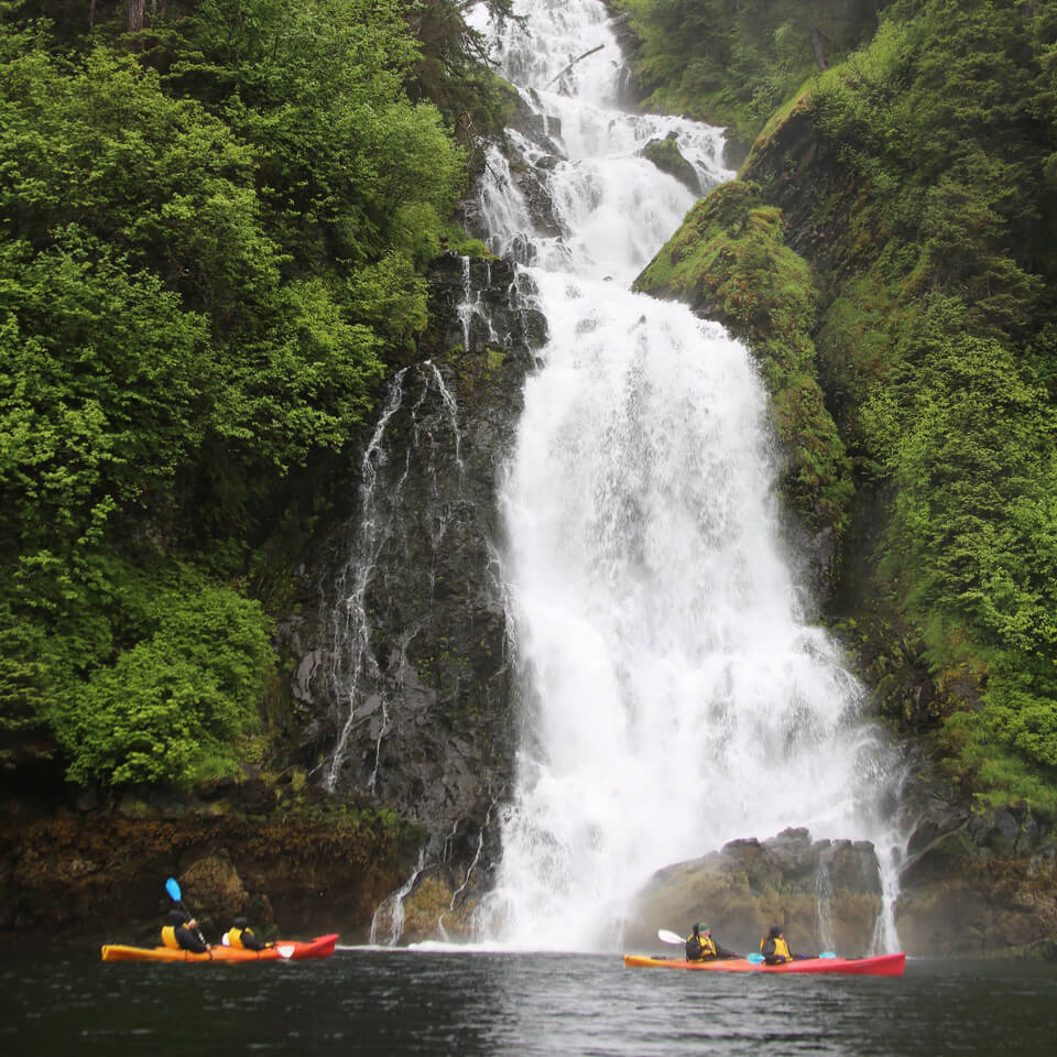 Sea Kayakers Near Waterfall